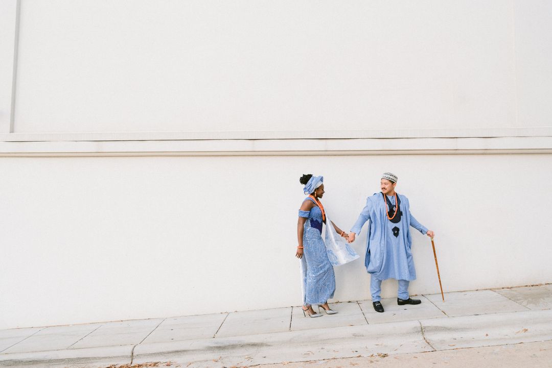 Amma and Lawrence holding hands in coordinated blue wedding attire